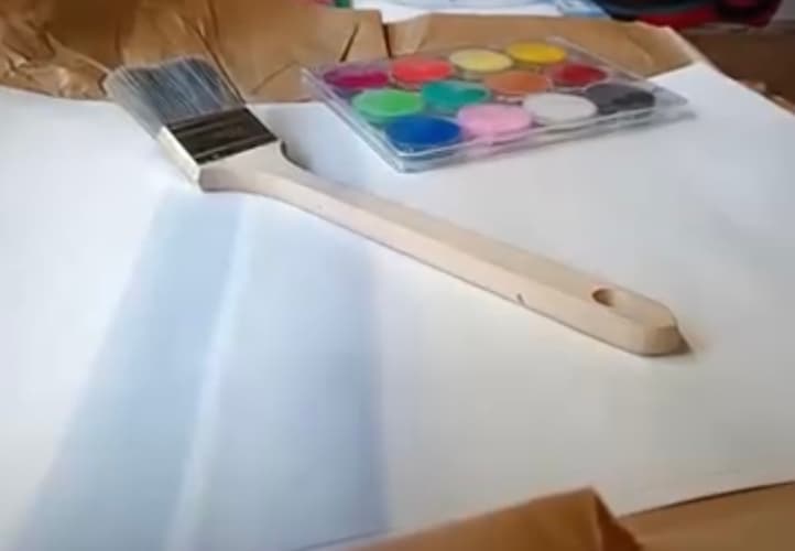 maalaustarvikkeita avoimen valkoisen piirustuspaperin päällä featured-image